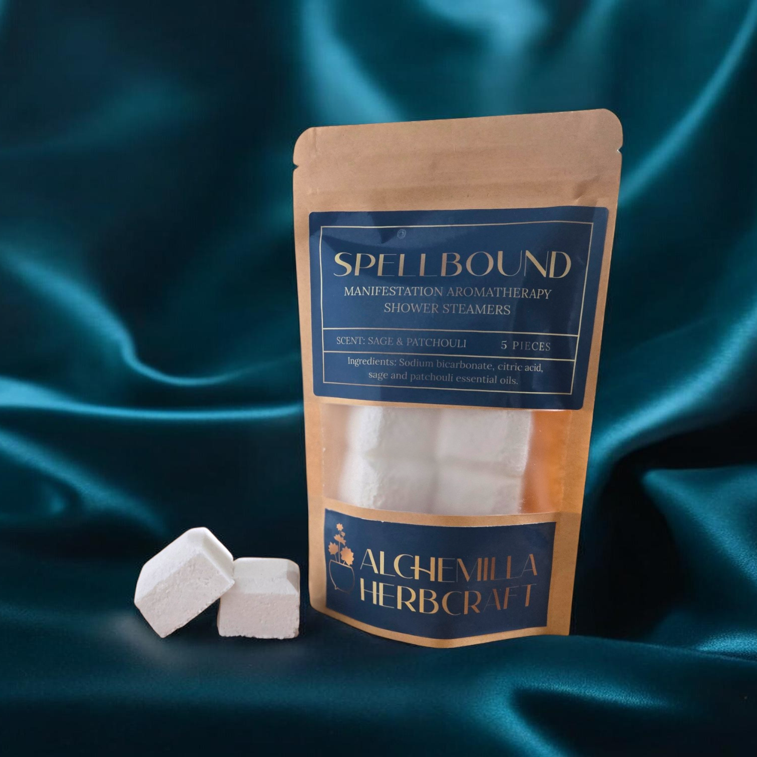 Sage and Patchouli shower steamers on a teal fabric